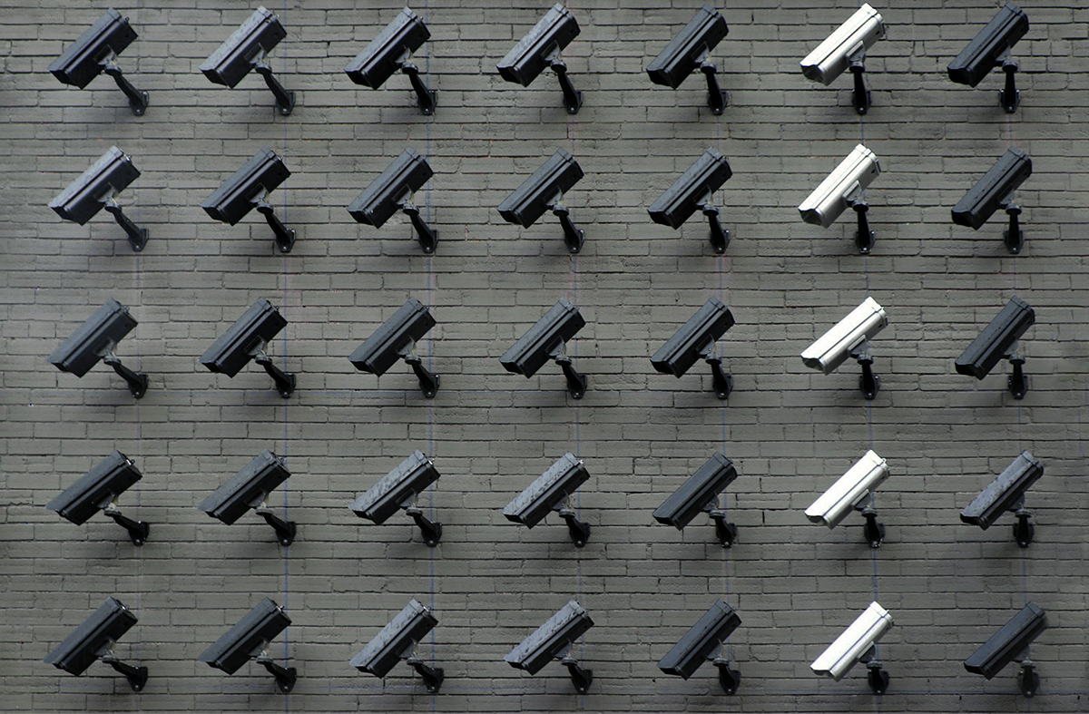 A image of a concrete sphere, balanced between two other larger spheres